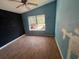 View of a bedroom with light blue walls and laminate flooring, and a window at 261 Acacia Walk, Lake Wales, FL 33898