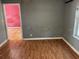 This living room features hardwood floors, fresh paint, and a window at 261 Acacia Walk, Lake Wales, FL 33898