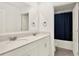 Bathroom features a double sink vanity with a large mirror and a view into the shower and toilet at 271 Inman Blvd, Winter Haven, FL 33881