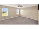 Spacious carpeted bedroom with dual windows and a ceiling fan at 271 Inman Blvd, Winter Haven, FL 33881