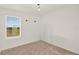 Neutral bedroom featuring neutral carpet and a large window at 271 Inman Blvd, Winter Haven, FL 33881