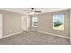 Large bedroom with carpeted floors, a ceiling fan, and large windows for natural light at 271 Inman Blvd, Winter Haven, FL 33881