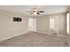 Spacious bedroom with neutral carpet, fan, and closet access at 271 Inman Blvd, Winter Haven, FL 33881