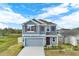 Charming two-story home features a gray exterior, red shutters, and a well-manicured lawn at 271 Inman Blvd, Winter Haven, FL 33881