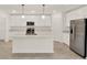 Contemporary kitchen with white cabinets, stainless steel appliances, and quartz countertops at 271 Inman Blvd, Winter Haven, FL 33881