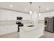 Well-lit kitchen featuring white cabinetry, modern appliances, and a functional island at 271 Inman Blvd, Winter Haven, FL 33881
