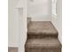 Carpeted staircase with white trim, leading to the upper level of the home at 271 Inman Blvd, Winter Haven, FL 33881
