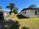 Spacious backyard with green grass and a mix of lush trees providing a peaceful outdoor setting at 2927 Walnut St, Winter Haven, FL 33881