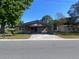 Charming single-story home with a carport and a well-maintained lawn in a quiet neighborhood at 2927 Walnut St, Winter Haven, FL 33881