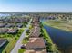 A stunning aerial view of a lakeside community, showcasing cozy single-Gathering homes with lush greenery at 3014 Ashton Palms Dr, Lake Wales, FL 33859