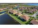 Charming single-story home with a screened lanai, lush landscaping, and tranquil water views at 3014 Ashton Palms Dr, Lake Wales, FL 33859