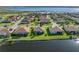 Waterfront property featuring a well-maintained lawn, mature trees, and beautiful lake views at 3014 Ashton Palms Dr, Lake Wales, FL 33859
