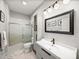 Clean, updated bathroom featuring a shower, vanity, and a large mirror at 3014 Ashton Palms Dr, Lake Wales, FL 33859