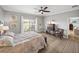 Bright bedroom with a large window, coastal-themed decor, and wood-look tile flooring at 3014 Ashton Palms Dr, Lake Wales, FL 33859