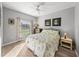 Well-lit bedroom with a ceiling fan, stylish decor, and a view from the window at 3014 Ashton Palms Dr, Lake Wales, FL 33859