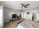 Relaxing bedroom featuring a ceiling fan, wood-look flooring, and ensuite access at 3014 Ashton Palms Dr, Lake Wales, FL 33859