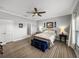 Large bedroom with an ensuite bathroom, wood look floors, ceiling fan and bedside tables at 3014 Ashton Palms Dr, Lake Wales, FL 33859
