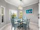 Cozy dining area featuring a glass table and stylish chairs illuminated by a modern chandelier at 3014 Ashton Palms Dr, Lake Wales, FL 33859