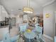 Open-concept with a cozy dining area featuring a glass table and stylish chairs connected to the kitchen and living room at 3014 Ashton Palms Dr, Lake Wales, FL 33859