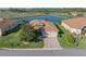 Beautiful single-story home with a brick driveway, attached garage, and serene water views at 3014 Ashton Palms Dr, Lake Wales, FL 33859
