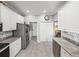 Spacious kitchen with stainless steel appliances and access to a laundry area at 3014 Ashton Palms Dr, Lake Wales, FL 33859