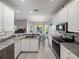 Bright, modern kitchen with stainless steel appliances, granite counters, and an adjacent dining area at 3014 Ashton Palms Dr, Lake Wales, FL 33859