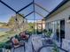Screened lanai with outdoor furniture and views of the garden and lake at 3014 Ashton Palms Dr, Lake Wales, FL 33859