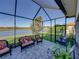 A covered lanai features comfortable seating and beautiful lake views at 3014 Ashton Palms Dr, Lake Wales, FL 33859