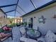 Screened in lanai with seating and dining space, perfect for entertaining at 3014 Ashton Palms Dr, Lake Wales, FL 33859