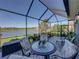 Spacious lanai with outdoor dining and seating overlooking the lake at 3014 Ashton Palms Dr, Lake Wales, FL 33859