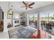 Living room featuring a modern fireplace, tile flooring, and a screened lanai with views of the lake at 3014 Ashton Palms Dr, Lake Wales, FL 33859