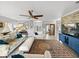 Inviting living room with ceiling fan, plush seating, and easy access to a home office or study space at 3014 Ashton Palms Dr, Lake Wales, FL 33859