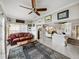 Open-concept living room with a large decorative rug, a ceiling fan, and an adjacent kitchen and dining area at 3014 Ashton Palms Dr, Lake Wales, FL 33859