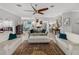 Stylish living room offers comfortable seating, tile floors, and a view of the adjoining kitchen and dining area at 3014 Ashton Palms Dr, Lake Wales, FL 33859
