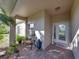 Cozy front porch with brick flooring, bench seating, and decorative plants at 3014 Ashton Palms Dr, Lake Wales, FL 33859