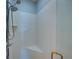 Modern walk-in shower with a bench, handheld showerhead, and tiled walls at 3014 Ashton Palms Dr, Lake Wales, FL 33859