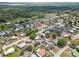 Aerial view of a residential area with single-Gathering homes surrounded by trees and a lake in distance at 319 Thomas Ave, Frostproof, FL 33843