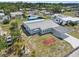 Aerial view of the home featuring metal roof, landscaping, and covered carport at 319 Thomas Ave, Frostproof, FL 33843