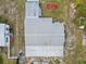 Aerial view of a single-Gathering home featuring a metal roof, carport, and spacious yard at 319 Thomas Ave, Frostproof, FL 33843