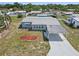 Aerial view showcasing the home, landscaping, and covered carport at 319 Thomas Ave, Frostproof, FL 33843
