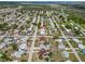 Aerial view of a residential area with single-Gathering homes near a lake and highway at 319 Thomas Ave, Frostproof, FL 33843