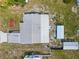 Aerial view of a single-Gathering home with a metal roof, carport, and additional structures at 319 Thomas Ave, Frostproof, FL 33843