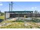 Backyard featuring a covered patio, wood fence, and well-maintained yard at 319 Thomas Ave, Frostproof, FL 33843