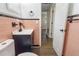 A well-maintained bathroom with unique tiling, a modern vanity, and a view to the adjacent hall at 319 Thomas Ave, Frostproof, FL 33843