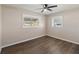 Comfortable bedroom with hardwood floors, white trim, and natural light at 319 Thomas Ave, Frostproof, FL 33843