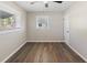 A comfortable bedroom with natural light, ceiling fan, and wood-look flooring creates an inviting space at 319 Thomas Ave, Frostproof, FL 33843