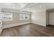 Spacious bedroom with wood-look flooring, natural light from windows, and a convenient closet at 319 Thomas Ave, Frostproof, FL 33843