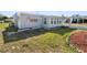 Exterior view of a light blue single-story home with well maintained landscaping at 319 Thomas Ave, Frostproof, FL 33843