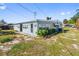 Exterior view of a light blue single-story home with satellite dishes at 319 Thomas Ave, Frostproof, FL 33843