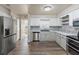 Modern kitchen with stainless steel appliances, white cabinets, and a stylish backsplash at 319 Thomas Ave, Frostproof, FL 33843
